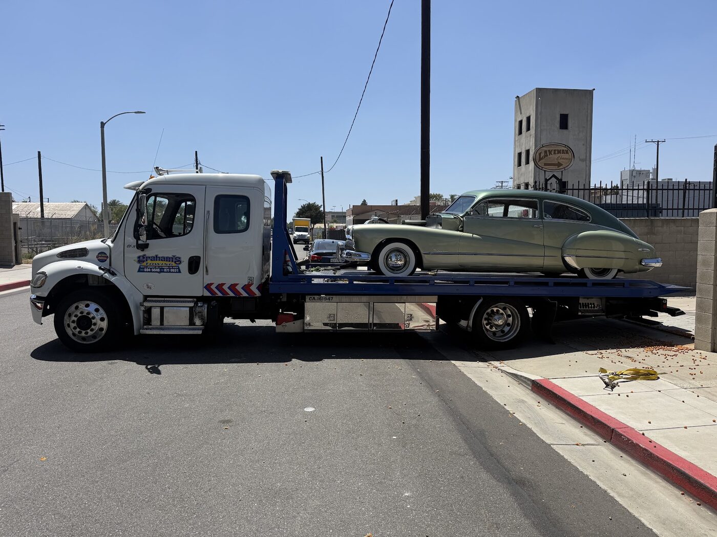 Classic green Buick transported on a Graham's Towing flatbed
